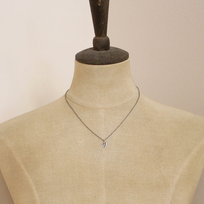 A mannequin wearing the bronze leaf necklace