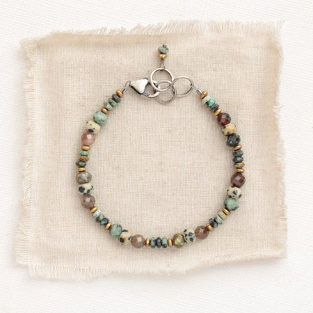 The lona bracelet styled on tan linen