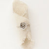 The mini cactus flower stacking ring styled on a piece of rolled linen