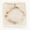 The mini cactus flower violet jade bracelet styled on tan linen