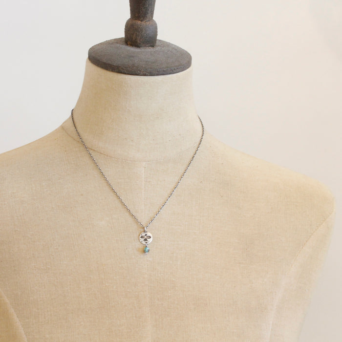 A mannequin wearing the mini soar and turquoise necklace