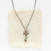 The mini soar and turquoise necklace styled on tan linen