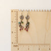 The mini sprout rainbow tourmaline earrings on a ruler for size reference