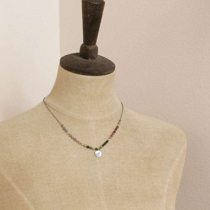 A mannequin wearing the knotted rainbow tourmaline mini sprout necklace