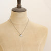 A mannequin wearing the mini sprout turquoise charm necklace
