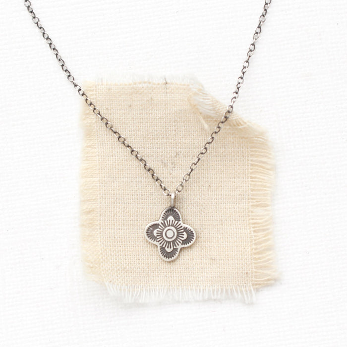 The mini talara necklace styled on tan linen