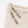 The kaleidoscope flowing leaf earrings styled on tan linen