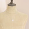 A mannequin wearing the silver moonstone drop necklace