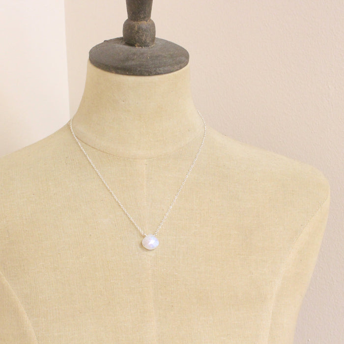 A mannequin wearing the silver moonstone drop necklace