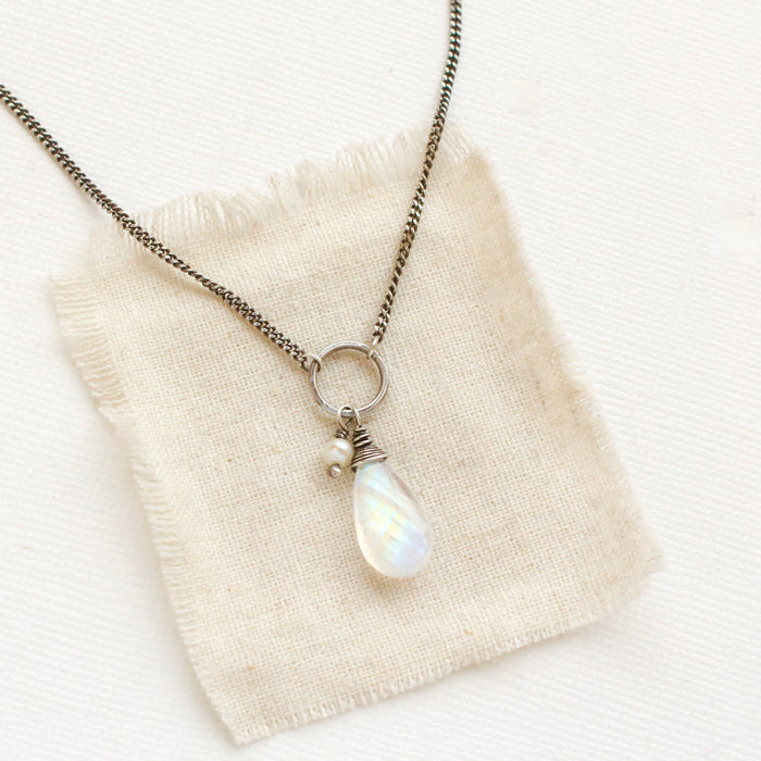 The moonstone and pearl necklace styled on tan linen