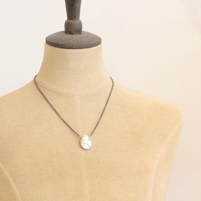 A mannequin wearing the organic pearl mixed metal necklace
