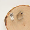 The pakal hoop post earrings styled on wood to show the post and butterfly ear back