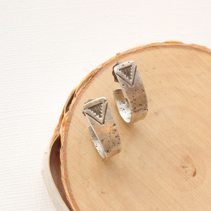 The pakal hoop post earrings styled on wood