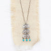 The pakal trio turquoise dangle necklace styled on tan linen