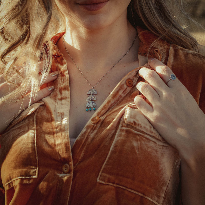 A model wearing the pakal turquoise trio necklace