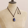 A mannequin wearing the pinned sodalite adjustable leather necklace to show the shorter length option
