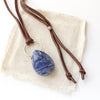 The pinned sodalite adjustable leather necklace styled on tan linen