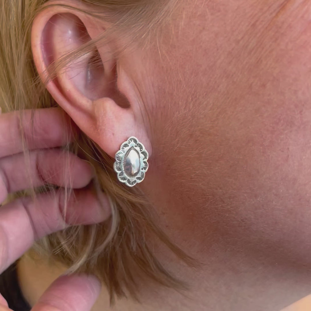 The jolene post earrings being worn
