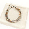 The rainbow agate sun bar double strand bracelet styled on tan linen