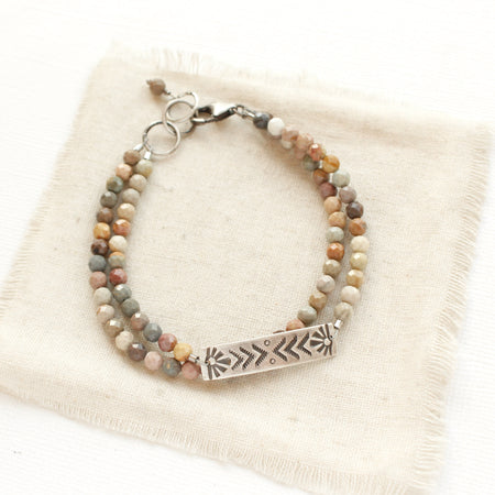 The rainbow agate sun bar double strand bracelet styled on tan linen