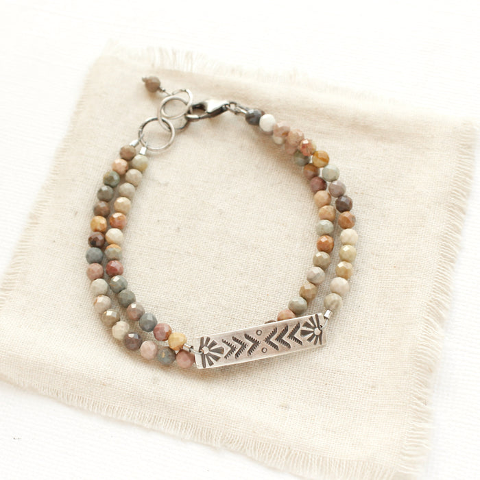 The rainbow agate sun bar double strand bracelet styled on tan linen