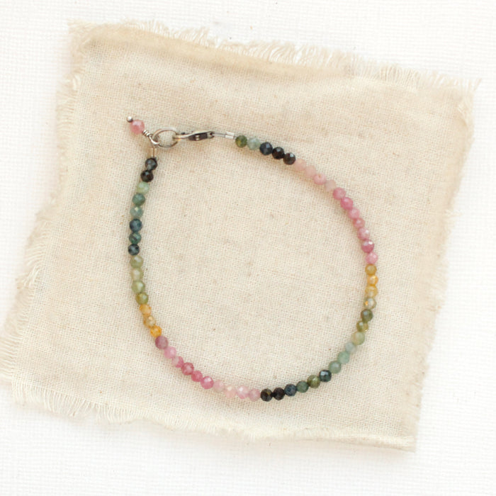 The rainbow tourmaline bracelet styled on tan linen