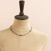 A mannequin wearing the rainbow tourmaline necklace