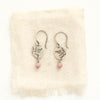 The rhodonite sprout earrings styled on tan linen