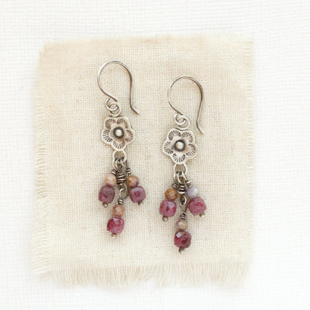 The mini cactus flower ruby and phosphosiderite earrings styled on tan linen
