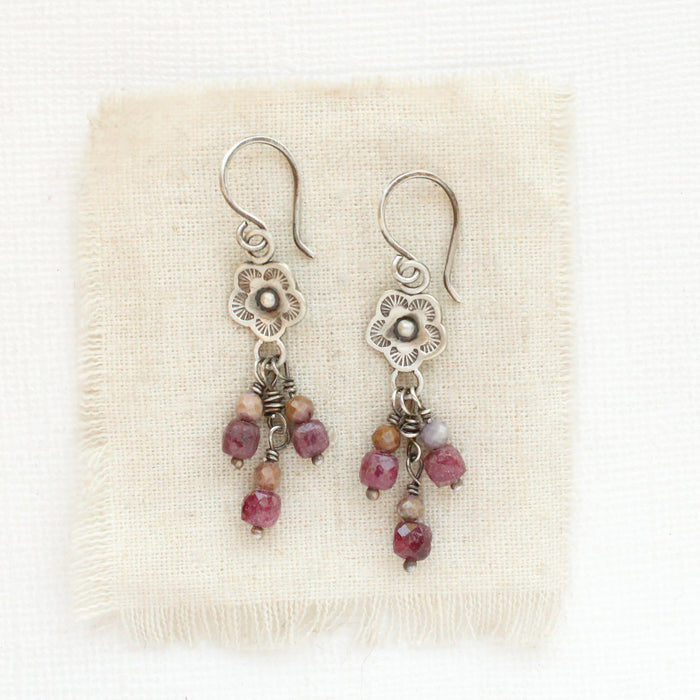 The mini cactus flower ruby and phosphosiderite earrings styled on tan linen