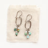 The seaside hoop earrings styled on tan linen