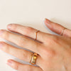 The silver momentum ring being worn on a hand