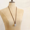 A mannequin wearing the silver wanderer adjustable leather necklace in the long style