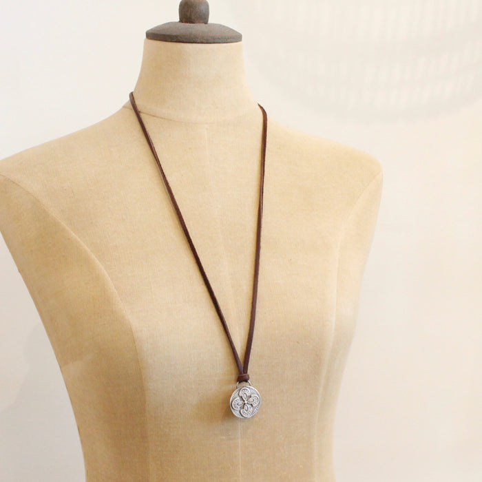 A mannequin wearing the silver wanderer adjustable leather necklace in the long style