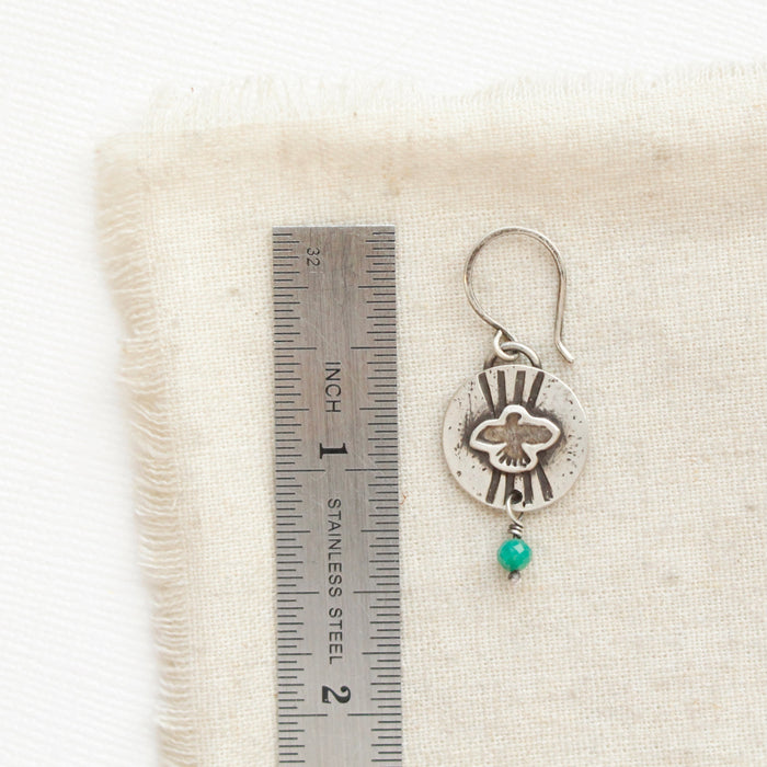 A layered soar amazonite earring next to a ruler for size reference