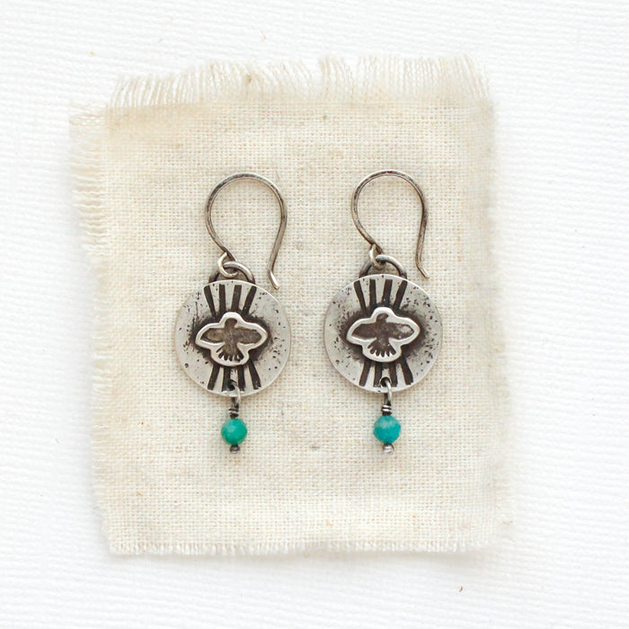 The layered soar amazonite earrings styled on tan linen