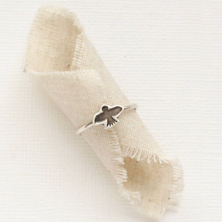 The soar stacking ring styled on a piece of rolled linen