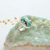 The southwest turquoise ring styled on a green crystal with dried grass