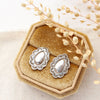 The jolene post earrings styled on a velvet box with linen and dried grass
