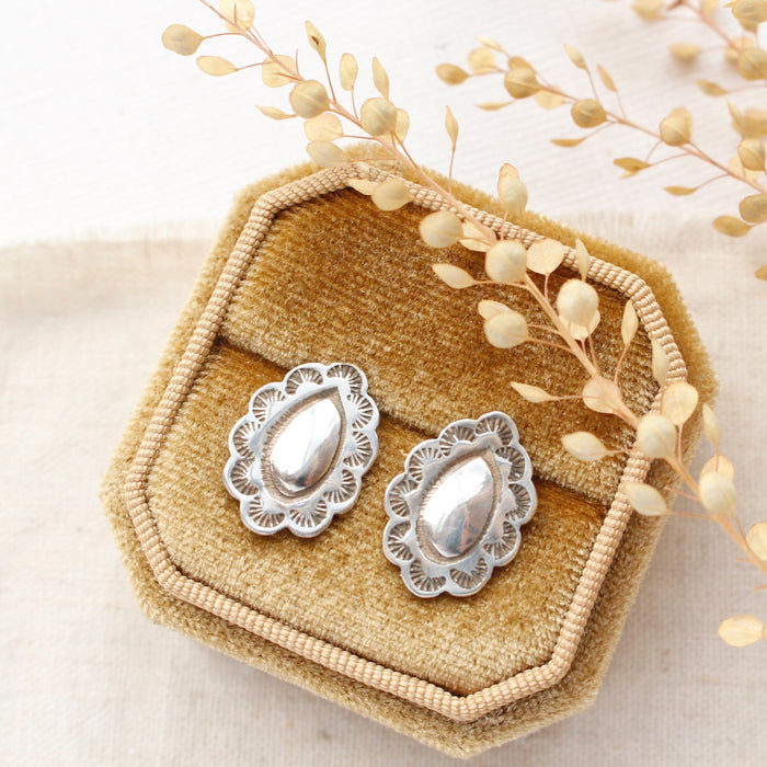 The jolene post earrings styled on a velvet box with linen and dried grass