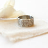 The nordic stamped band ring styled on tan linen