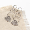 the asmi triangle double loop earrings styled on tan linen