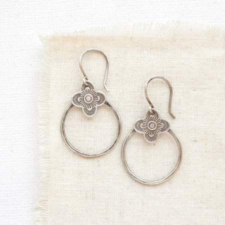 The talara hoop earrings styled on tan linen