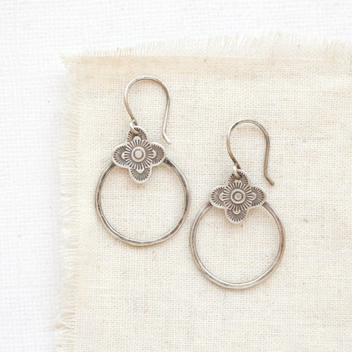 The talara hoop earrings styled on tan linen