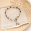 The talara sun andesine bracelet styled on a tan plate with linen and dried grass