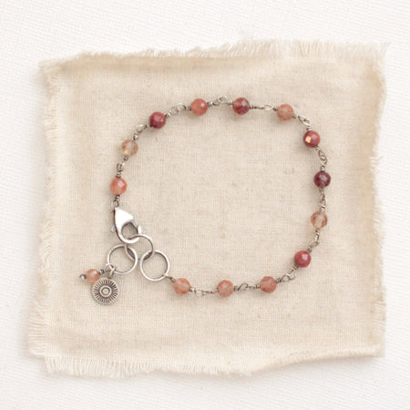 The talara sun andesine bracelet styled on tan linen