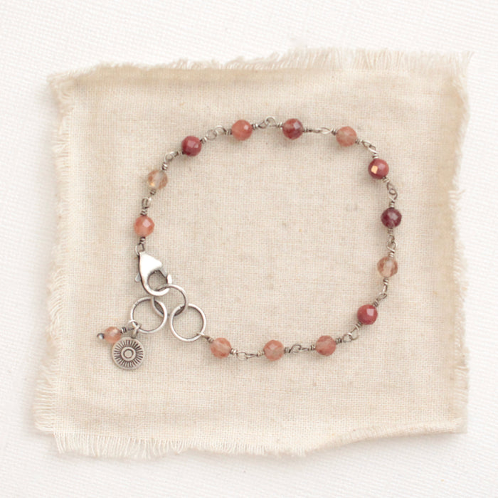 The talara sun andesine bracelet styled on tan linen