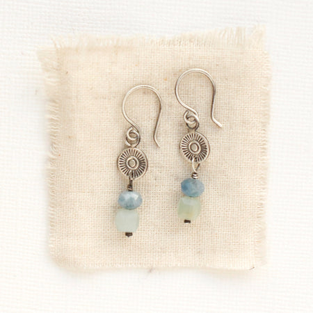 The talara sun aquamarine earrings styled on tan linen