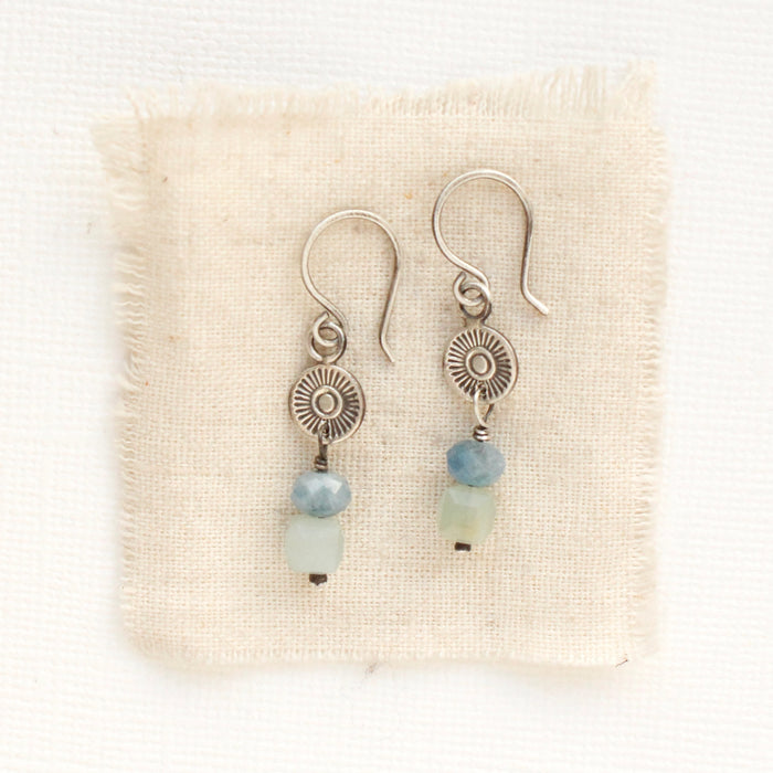 The talara sun aquamarine earrings styled on tan linen