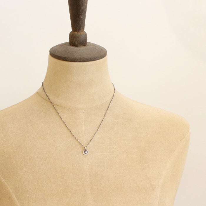 A mannequin wearing the mini talara sun necklace